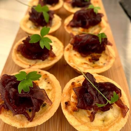     Mini goats cheese tartlets dressed with homemade red onion relish   