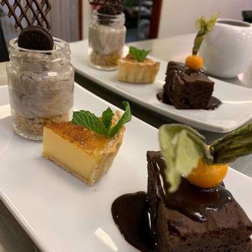 Trio of Desserts: Cookies & Cream cheesecake, Glazed Lemon Tart & Warm Chocolate Brownie with Chocolate Sauce