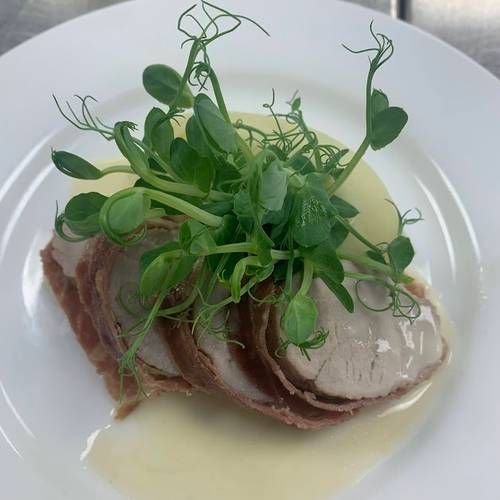 Pan seared pork tenderloin wrapped in Parma ham with cider cream sauce and a buttered mash 